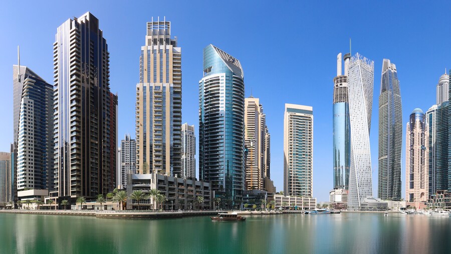 Dubai Marina at day with boat and blue sky, UAE