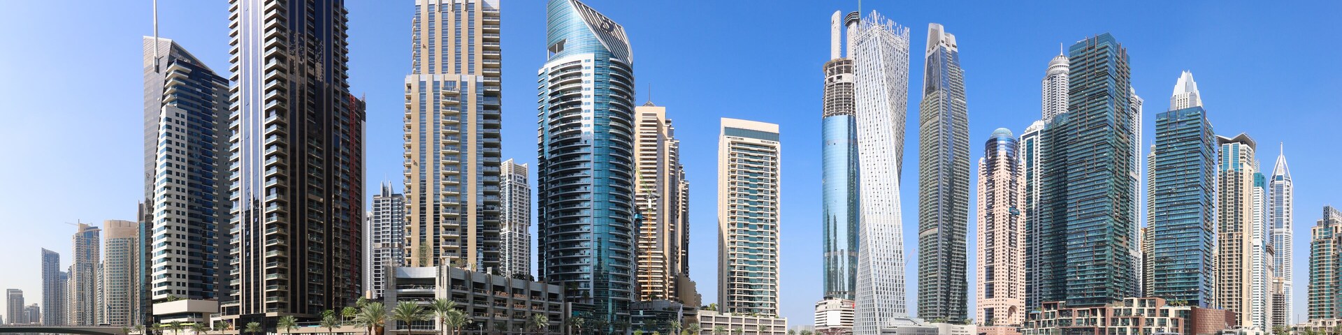 Dubai Marina at day with boat and blue sky, UAE