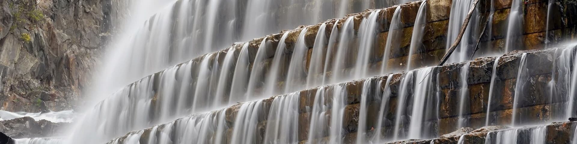 The New Croton Dam, in Westchester County, has an unusual spillway, part artificial and part natural, which forms a waterfall on the north side of the structure. New Croton Dam has a public park and trail head at its base and a road along its crest. After the events of 9/11, road use was limited to pedestrians and emergency vehicles.