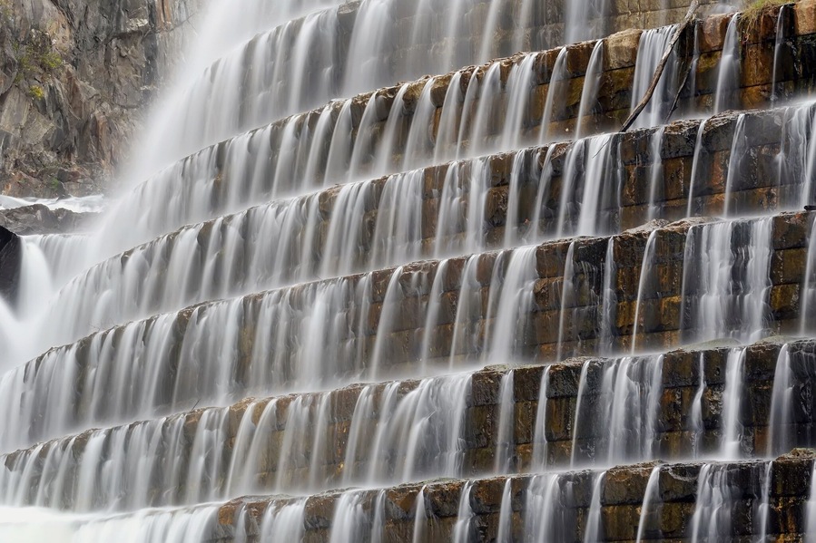 The New Croton Dam, in Westchester County, has an unusual spillway, part artificial and part natural, which forms a waterfall on the north side of the structure. New Croton Dam has a public park and trail head at its base and a road along its crest. After the events of 9/11, road use was limited to pedestrians and emergency vehicles.