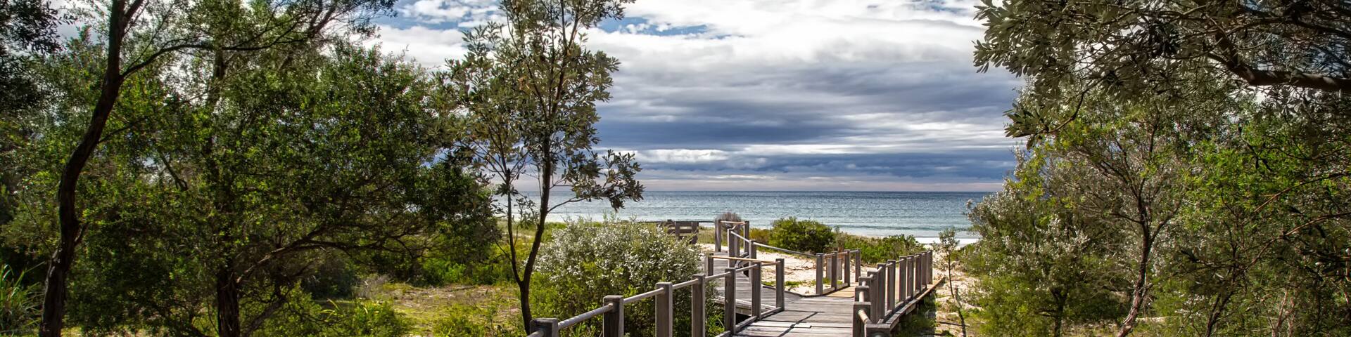 A wooden boardwalk leading to 7 Mile Beach near Gerroa in Australia