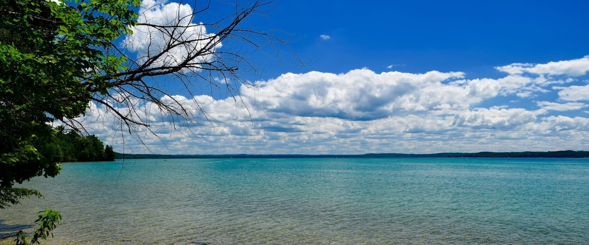 At 19 miles long and over 18,000 acres Torch Lake is Michigan's second largest lake, with a shoreline dotted with little secluded beaches. It is considered to be one of the top five clearest lakes in the world. I've never seen such clear water! #blue #colorful #AquaTrove #BeachTips #Nature