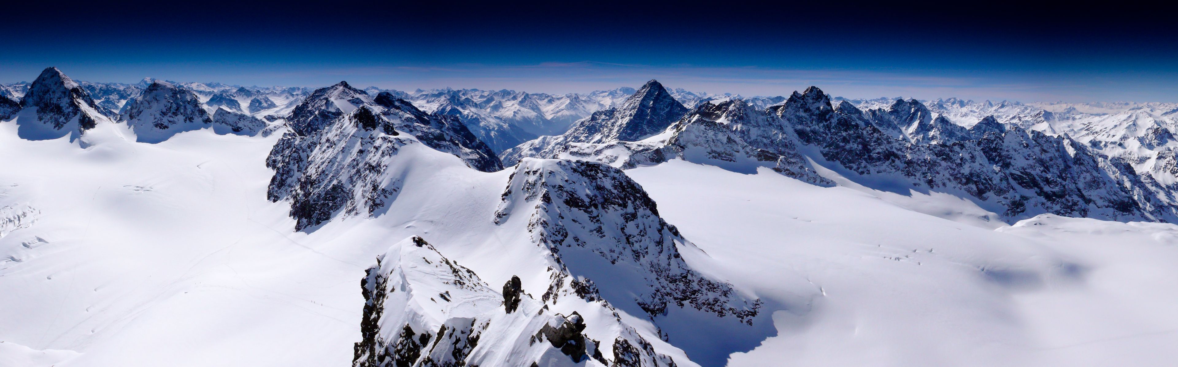 fantastic winter mountain panorama with a view of the high peaks and glaciers of the Silvretta mountains in the Swiss Alps on a beautiful winter day