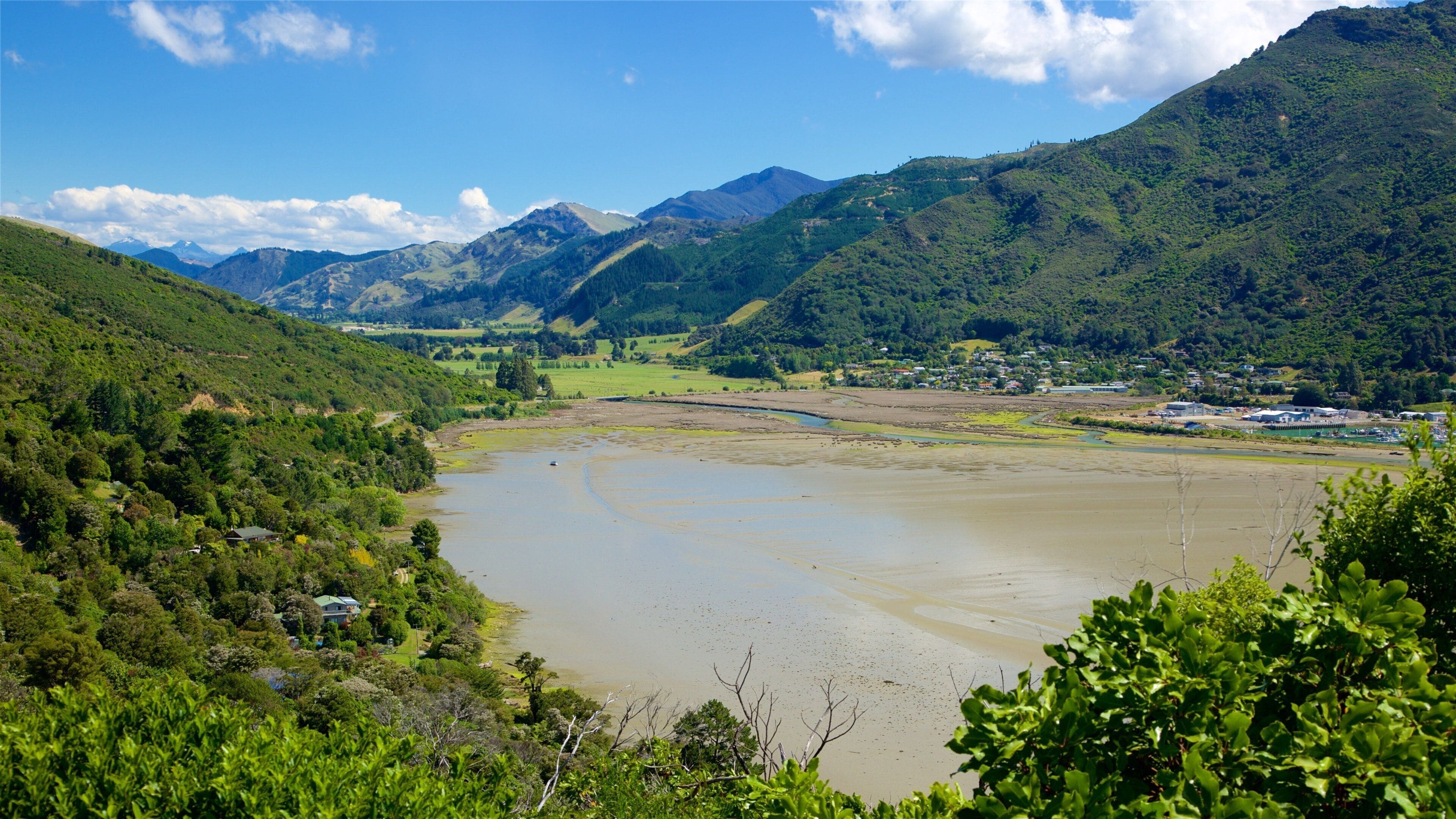 Um rio serpenteando por um vale rodeado por montanhas.