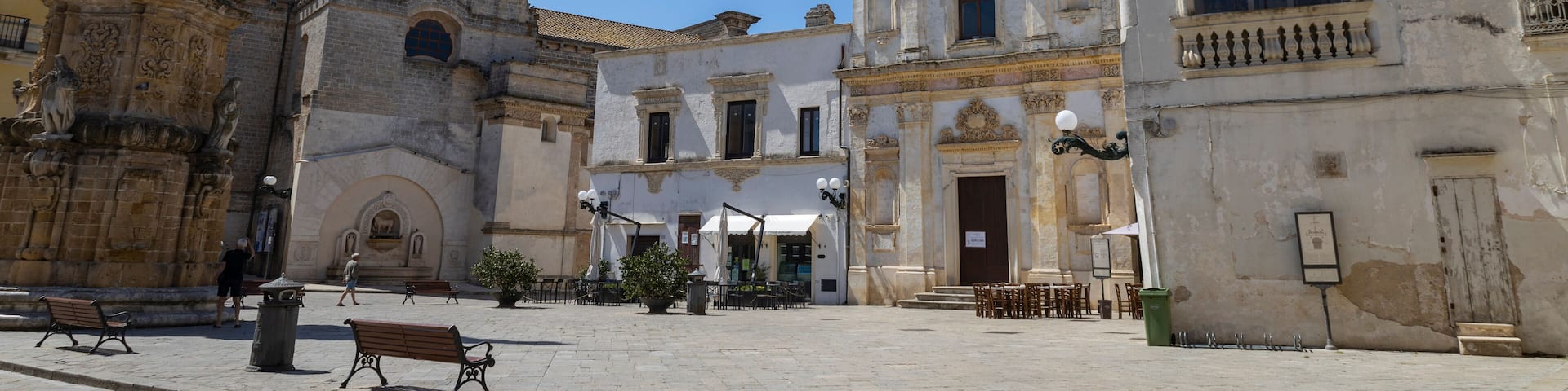 NARDO', ITALY, JULY 17, 2022 - View of the church of Saint Tryphon (San Trifone) and the Spire of the Immaculate in the center town of Nardò, province of Lecce, Puglia, Italy