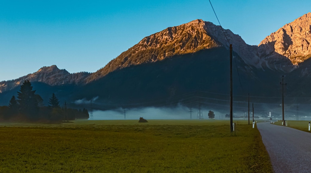 High resolution stitched panorama of a beautiful alpine foggy sunrise view at the famous Heiterwanger See lake near Bichlbach, Tyrol, Austria