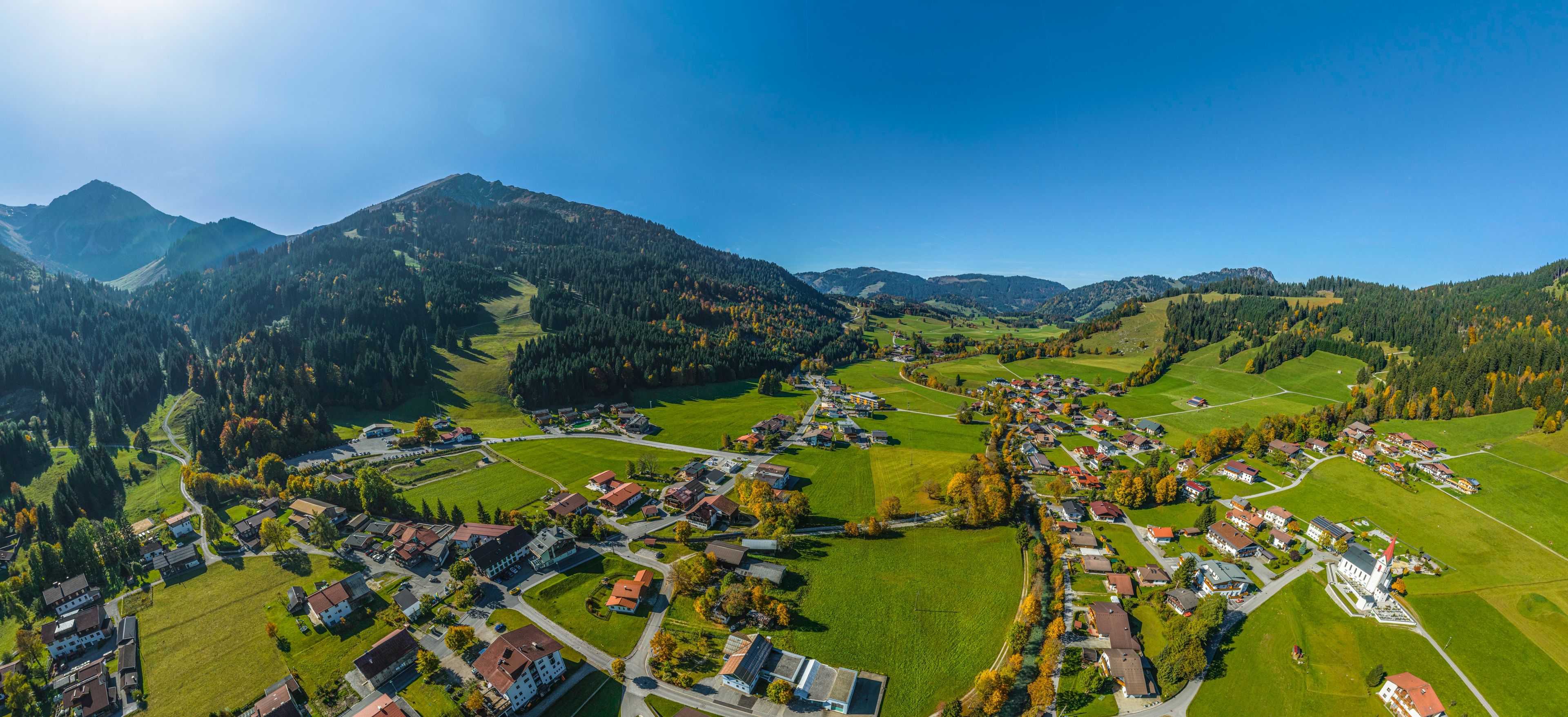 A mountainous landscape with a village nestled in the valley.