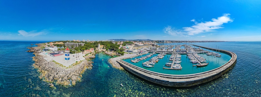 Cascais, Portugal - Aerial view of the Portuguese coastline, marina, beaches and villas of Cascais during heatwave in summer