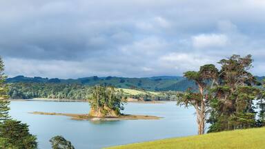 A lake surrounded by hills and trees.