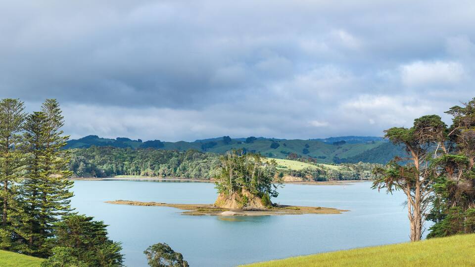 A lake surrounded by hills and trees.