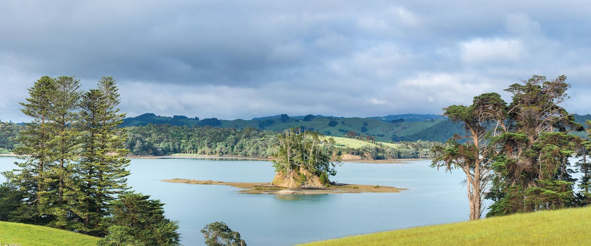 A lake surrounded by hills and trees.