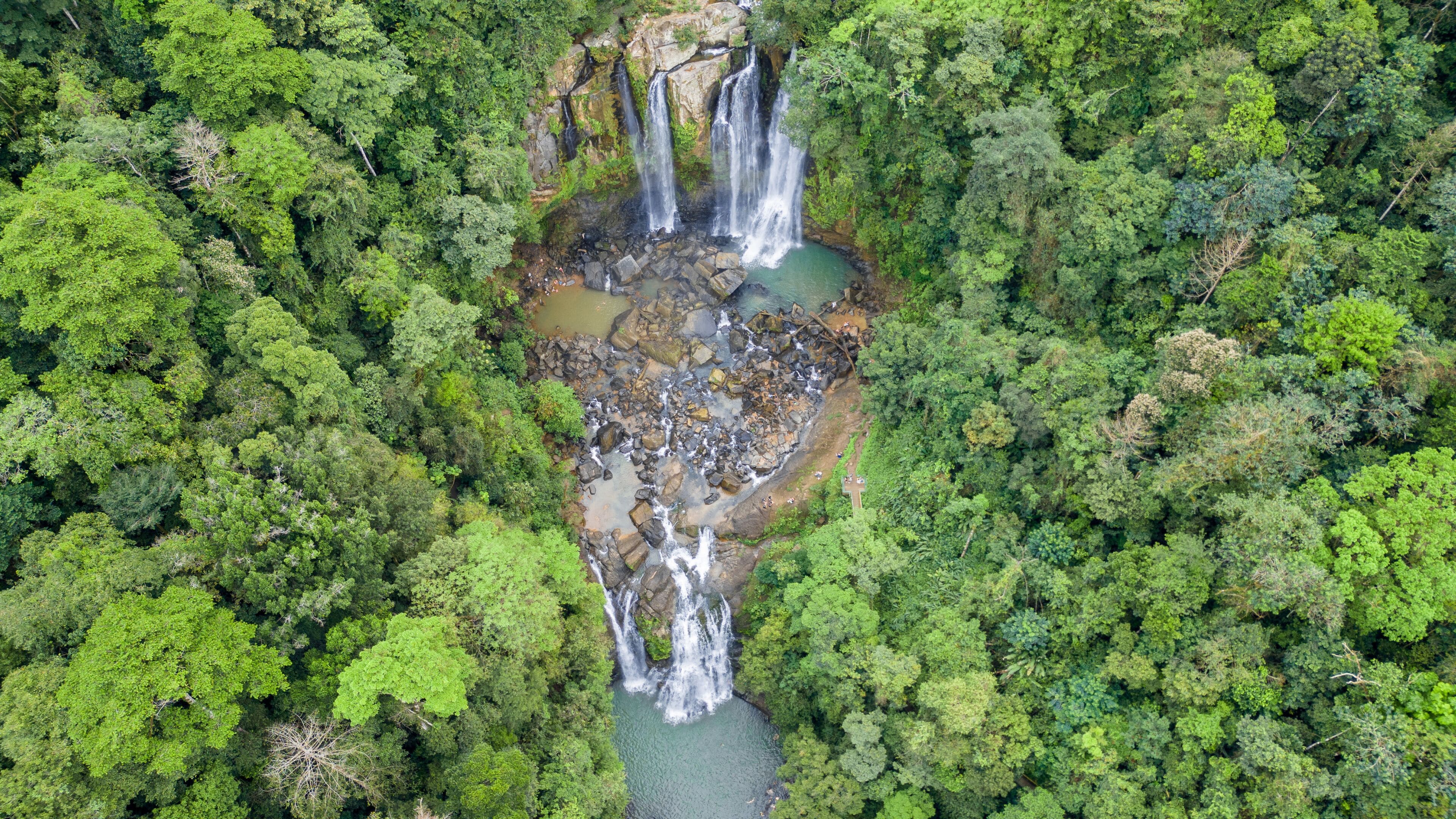 Aerial panoramic shot of the top of the Nauyacas Waterfalls of the Baru River in the middle of the green tropical forest in Costa Rica
