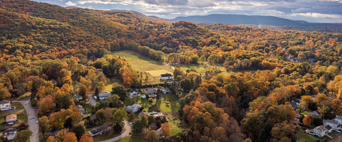 Aerial view of vibrant autumnal foliage covering a mountain in Cornwall-on-Hudson, New York