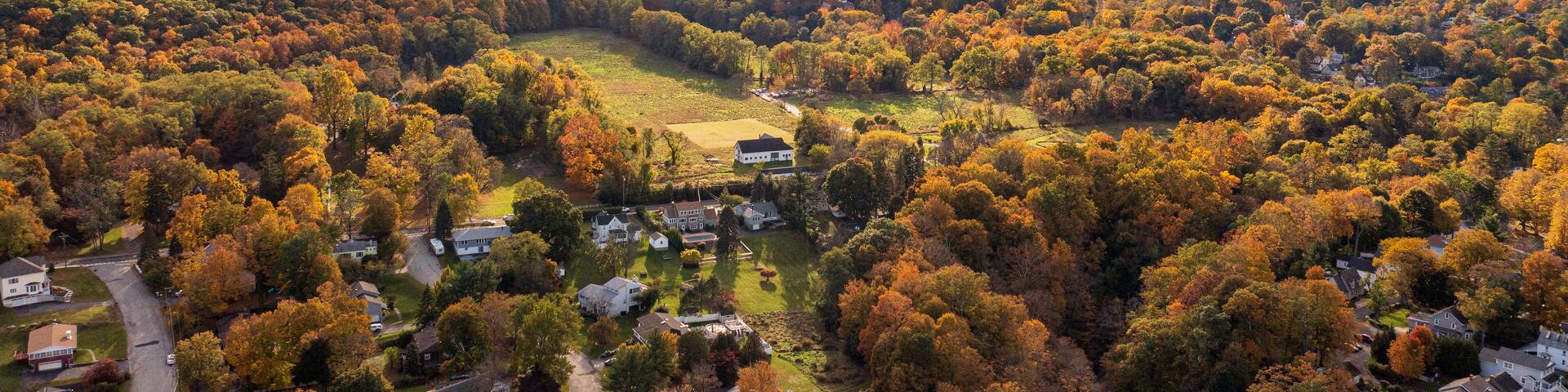 Aerial view of vibrant autumnal foliage covering a mountain in Cornwall-on-Hudson, New York