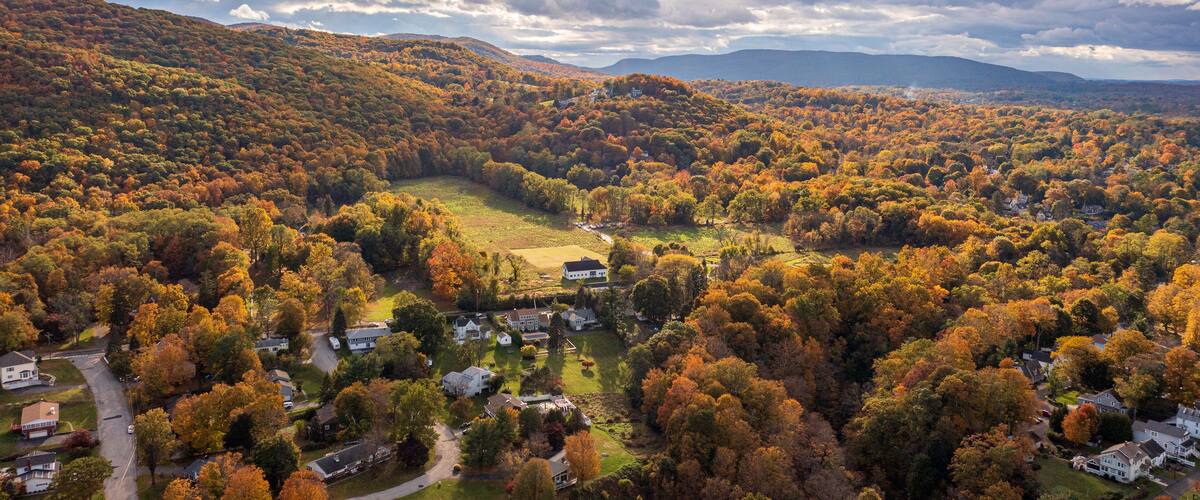 Aerial view of vibrant autumnal foliage covering a mountain in Cornwall-on-Hudson, New York