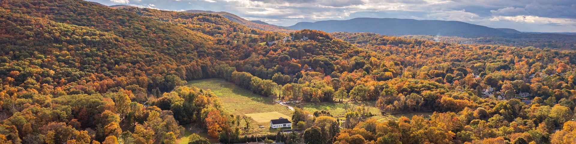 Aerial view of vibrant autumnal foliage covering a mountain in Cornwall-on-Hudson, New York