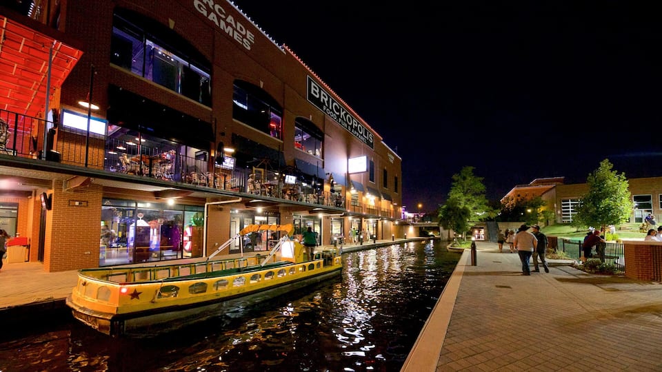Bricktown showing a river or creek and night scenes
