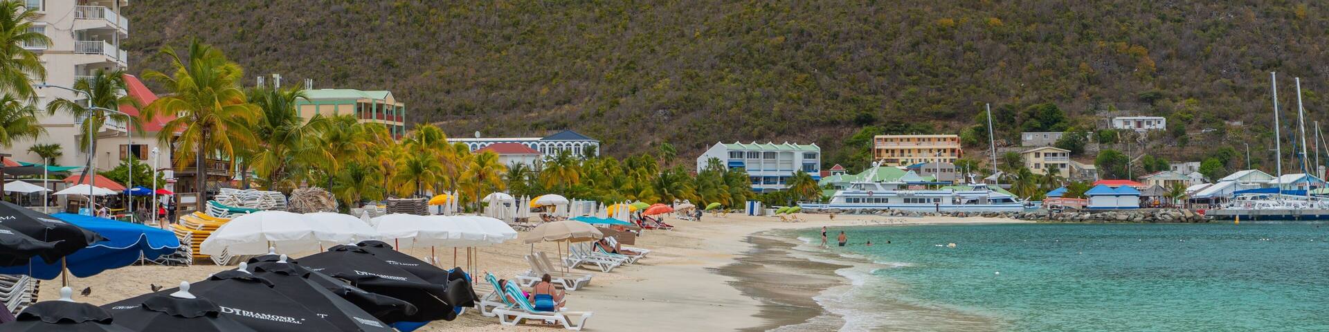 Great Bay Beach which includes a coastal town, a sandy beach and general coastal views