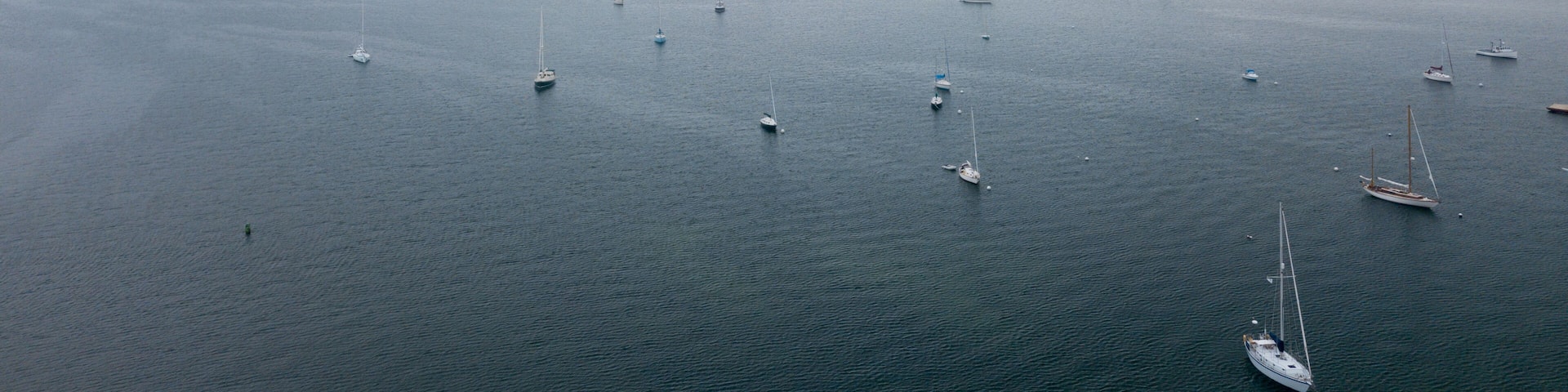 Lobster Fishing boats and other pleasure boats moored in Rockland Harbor inside the Breakwater as viewed from an aerial drone image