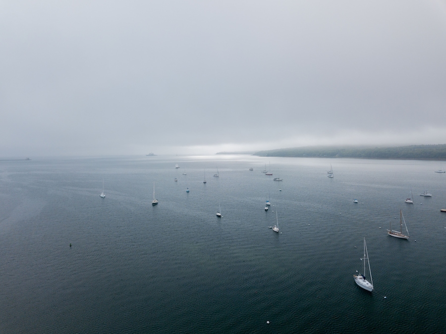 Lobster Fishing boats and other pleasure boats moored in Rockland Harbor inside the Breakwater as viewed from an aerial drone image