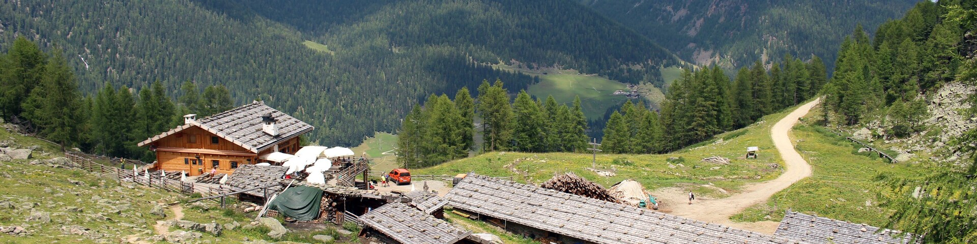 Blick auf die Fiechtalm (2034 m.ü.M.) oberhalb des Weißbrunnsees (1900 m.ü.M.) im Südtiroler Ultental (Val D'Ultimo).