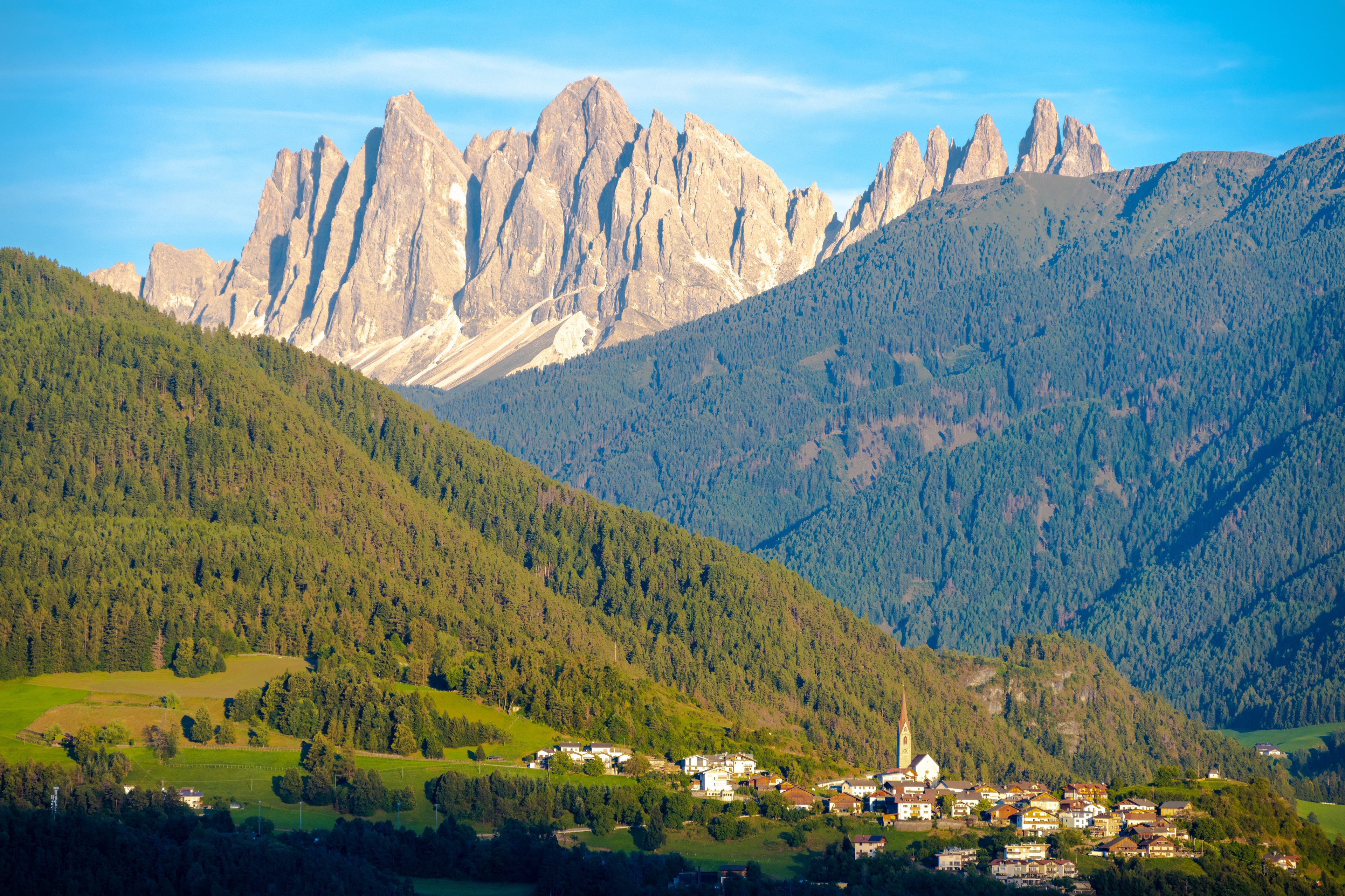 view on Tiso village with Dolomites mountains during sunset in Italy
