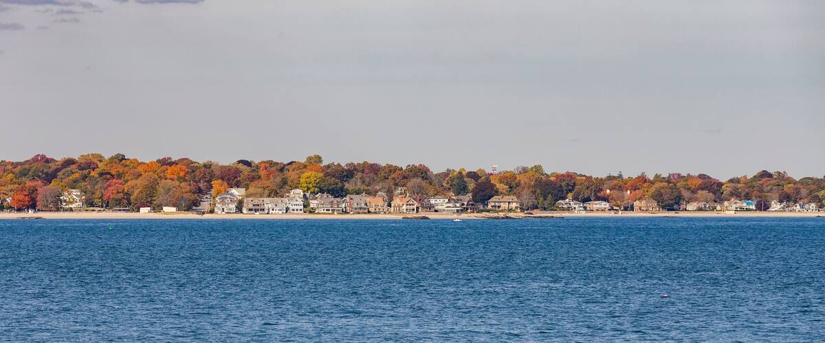 view to coast of New London t on a sunny day with old traditional wooden houses at the beach