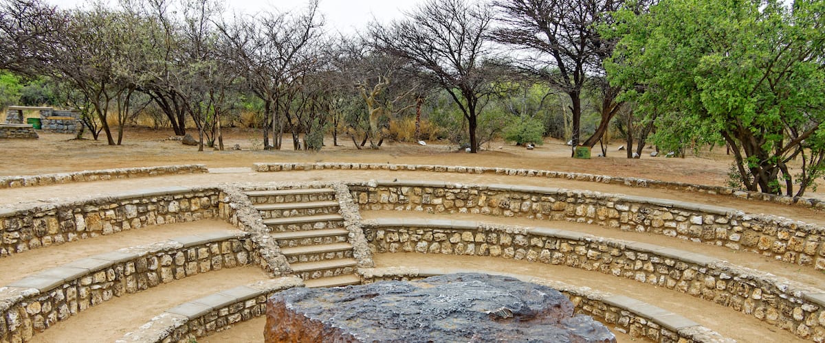A stone amphitheater with a central rock.