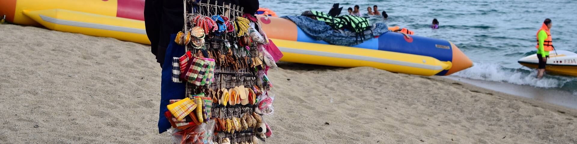 Laiya, San Juan, Batangas, Philippines - October 31, 2016: Lady street vendor selling tourist souvenirs at sea side resort