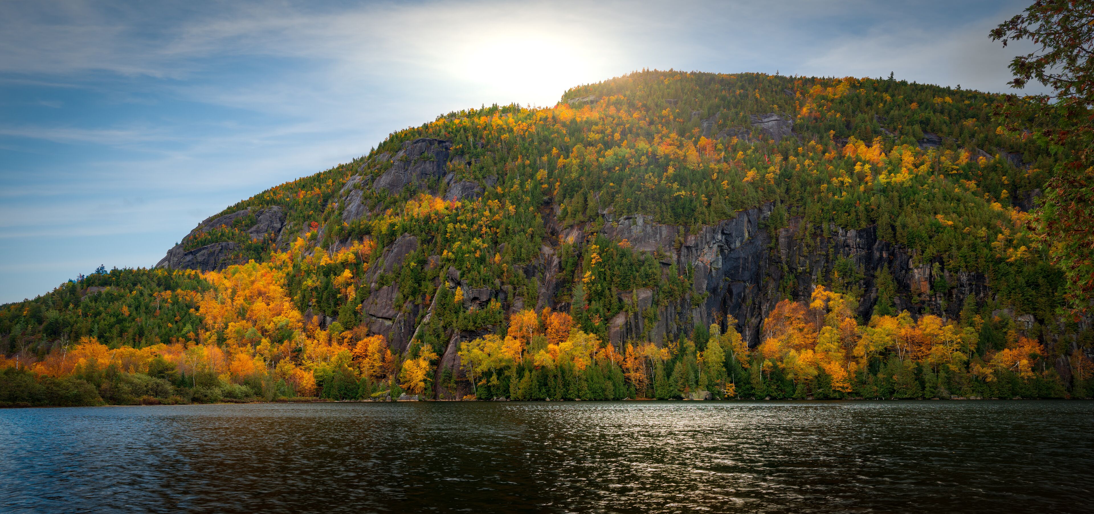 Panoramic view of Chapel Pond reflecting autumn colors in Keene Valley, the Adirondacks, New York