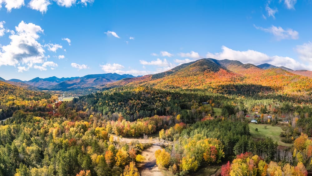 Aerial view of the Adirondack Mountain Range and Ausable River in Keene Valley, New York during autumn.