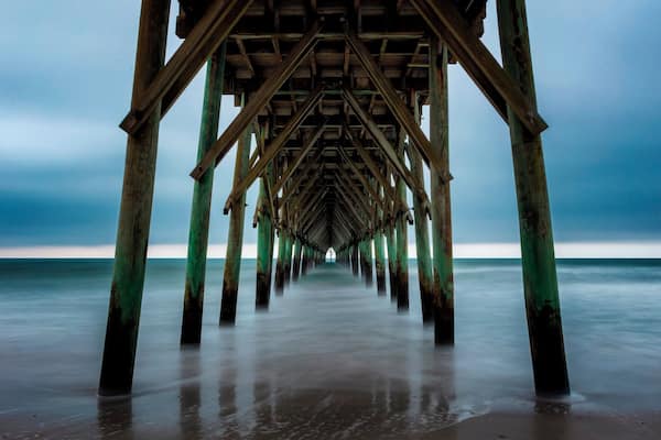 I may have uploaded a few from here. It's because I always love coming here right before sunrise and watching the waves come in. Today it was very calm. I was able to get a very dark mood with the rainclouds in the background.