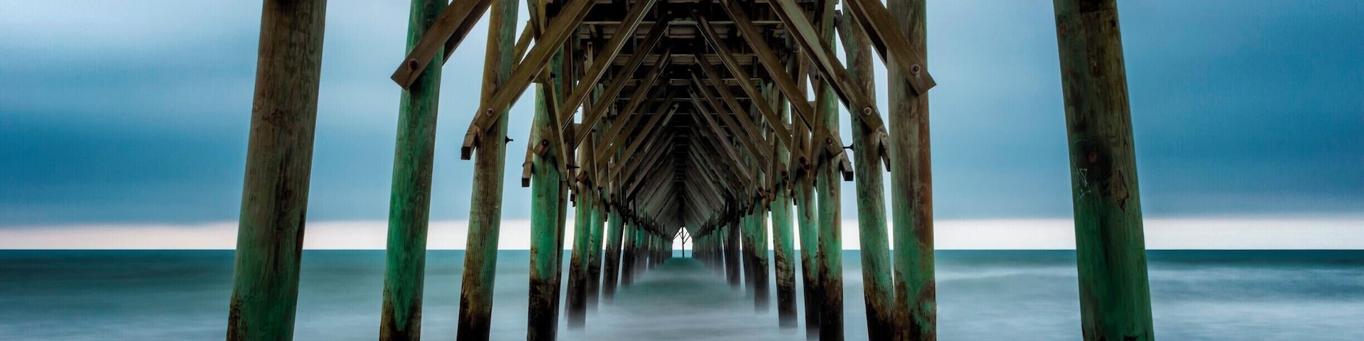 I may have uploaded a few from here. It's because I always love coming here right before sunrise and watching the waves come in. Today it was very calm. I was able to get a very dark mood with the rainclouds in the background.