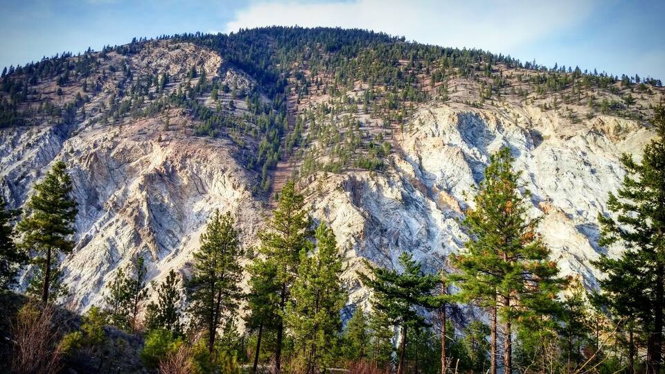 A mountainous landscape with dense forests and rugged terrain.