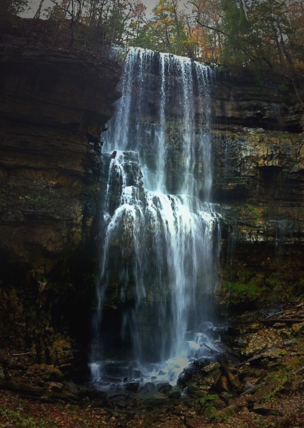 A unique waterfall located in Middle Tennessee.  The water flows out of a cave at the top of the falls, travels twenty yards,  falls 90 feet, and sinks back into a cave behind the waterfall at the base.    