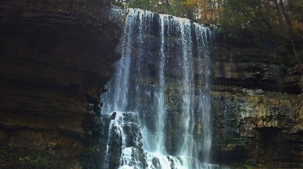 A unique waterfall located in Middle Tennessee. The water flows out of a cave at the top of the falls, travels twenty yards, falls 90 feet, and sinks back into a cave behind the waterfall at the base.