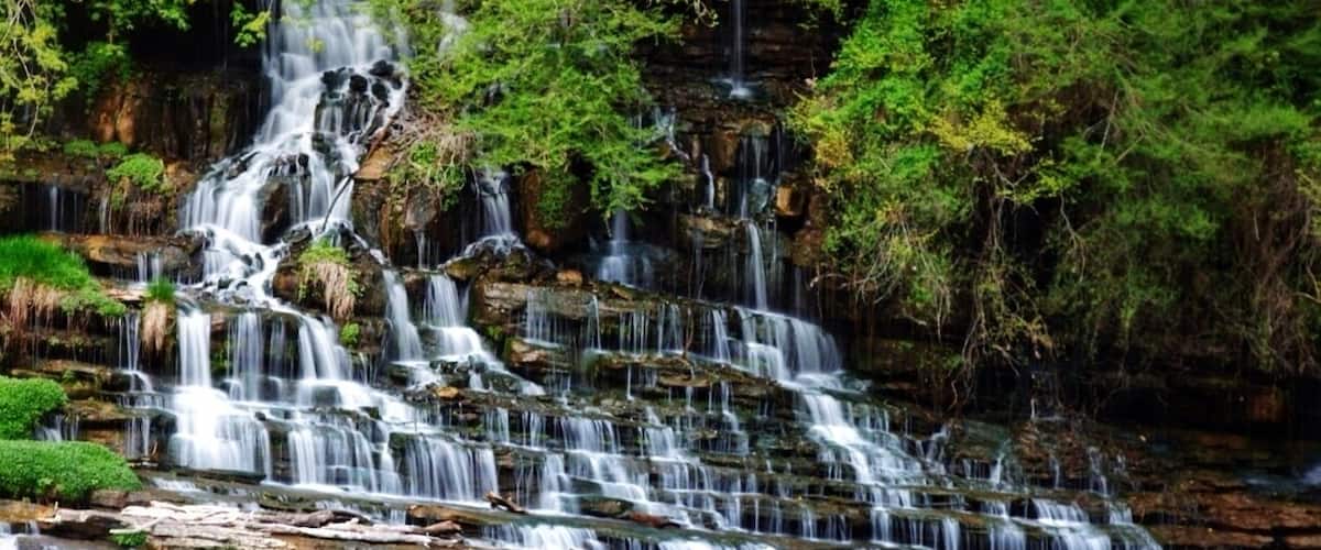 The main falls in rock island state park are a site to see. They stretch a few hundred feet wide! Slowly cascading down a side of a rock faced wall. It is a short but tenuous hike to see the falls. But, they are some of the best you can see in the south east. Maybe not the tallest or most water flowing, but it is a beautiful, slow, and pooling fall. As an added bonus the river it flows into is controlled by a dam, so you can at times get up to the waterfall, and at other times raft the river which I'm guessing is a class 3-4. A friend of mine has rafted it from the northern most spot to put in to the falls, and he said it was technical, he's done it a few times now.