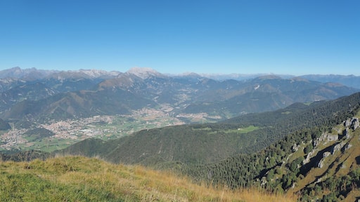 4K Drone aerial view to the Seriana valley and Orobie Alps in a clear and blue day. View of the highest mountains. Landscape from Pizzo Formico Mountain, Bergamo, Italy