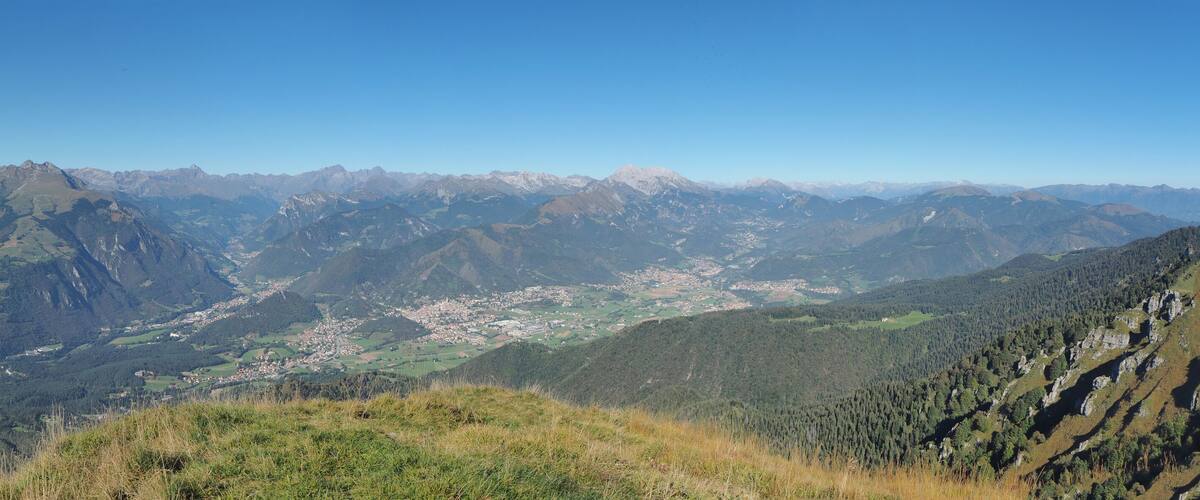 A mountainous landscape with a valley and a small town.