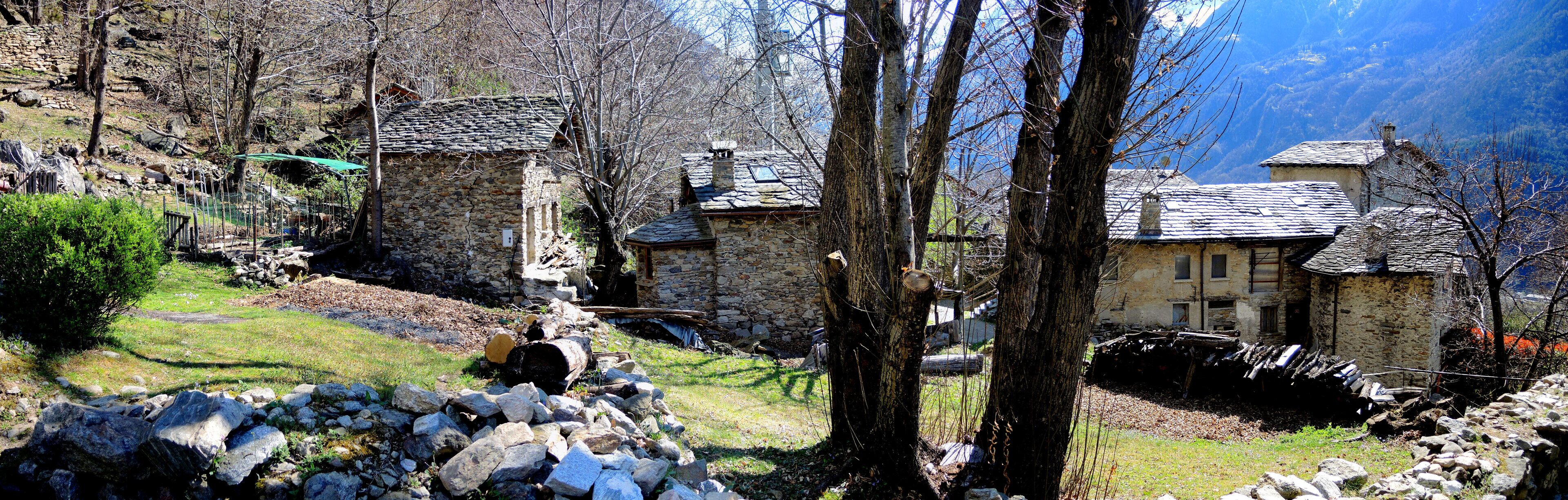 A mountainous village with stone houses, rocky terrain, and sparse vegetation.