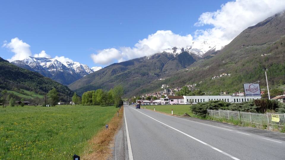 A road with a mountain range in the background.