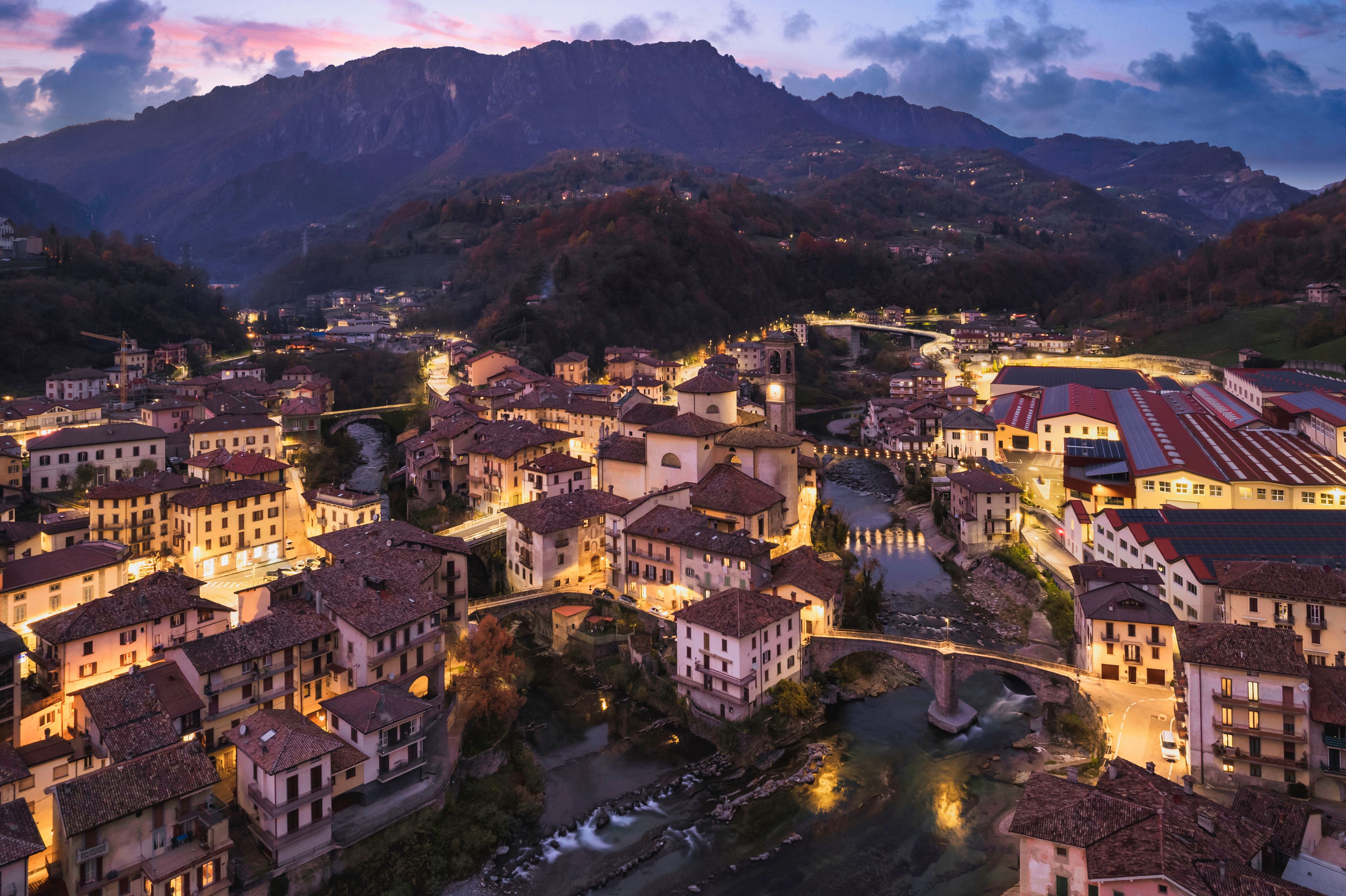 Beautiful aerial night cityscape of little town in Bergamo at blue hour, San Giovanni Bianco, Bergamo, Val Brembana, Lombardy, Italy
