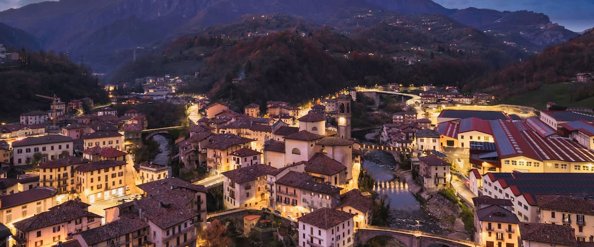 Beautiful aerial night cityscape of little town in Bergamo at blue hour, San Giovanni Bianco, Bergamo, Val Brembana, Lombardy, Italy