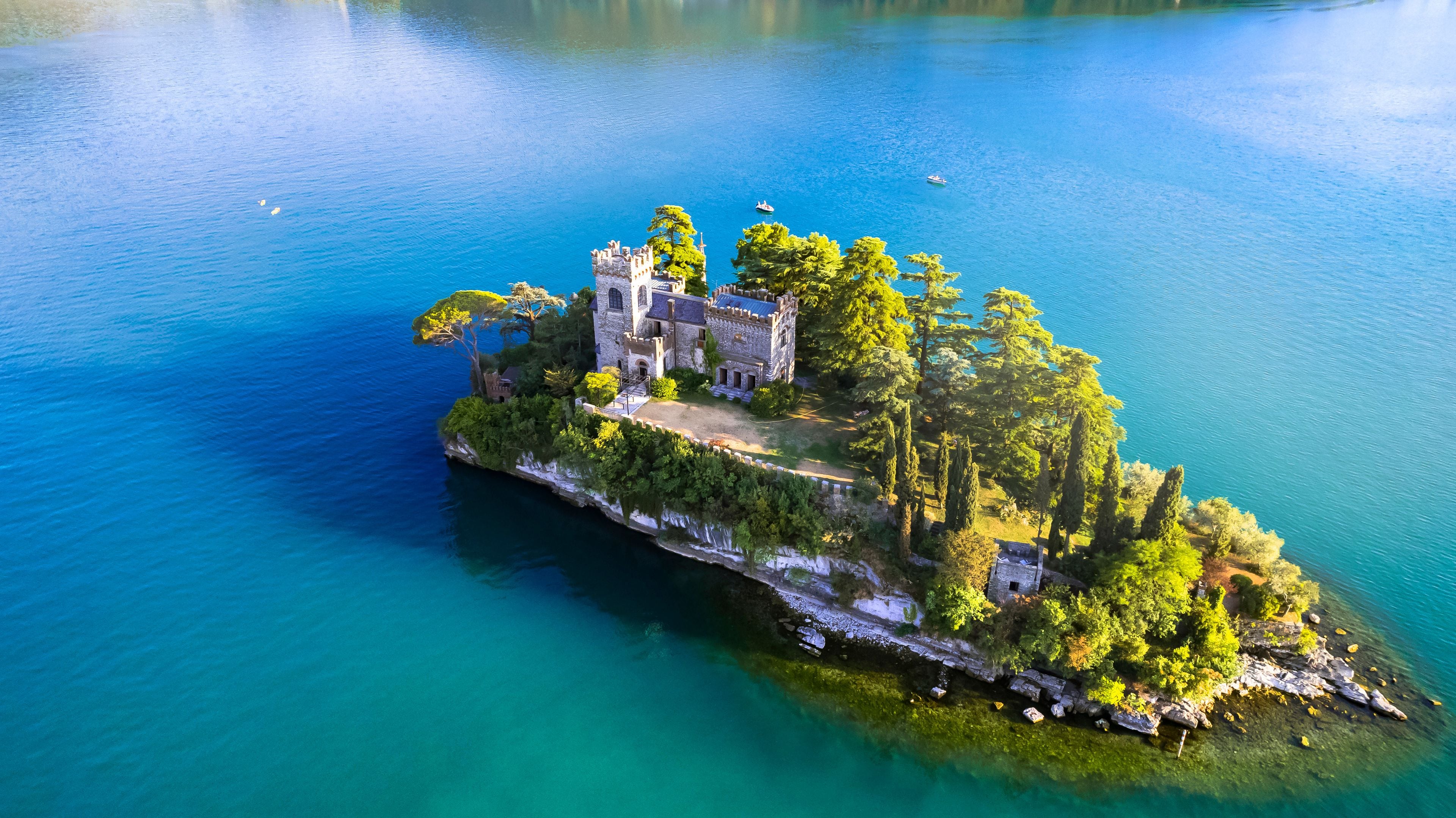 Isola di Loreto Castle on Lake Iseo Aerial View. Italy Brescia Lombardy. Picturesque Island with Neo-Gothic Villa and Turquoise Water Landscape 5K
