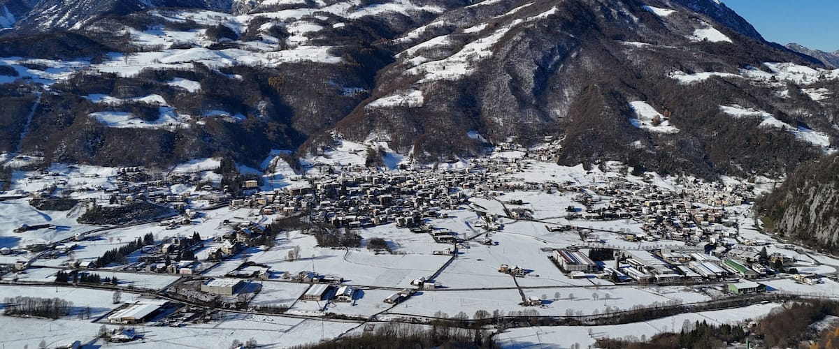A snow-covered mountain range with a town nestled at its base.