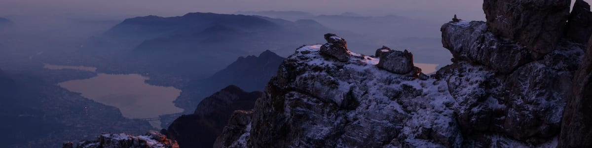 At dusk on the summit of Mount Grigna, on a cold evening of December.