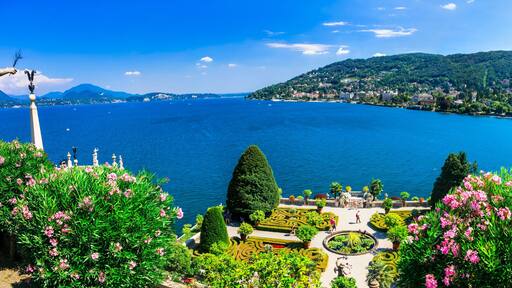 Ultra-wide panorama of Isola Madre botanical gardens and Lake Maggiore. Scenic aerial-style view of Borromean Islands and Alpine lake landscape, Italy.