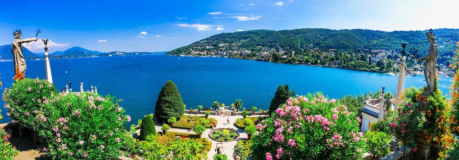Ultra-wide panorama of Isola Madre botanical gardens and Lake Maggiore. Scenic aerial-style view of Borromean Islands and Alpine lake landscape, Italy.