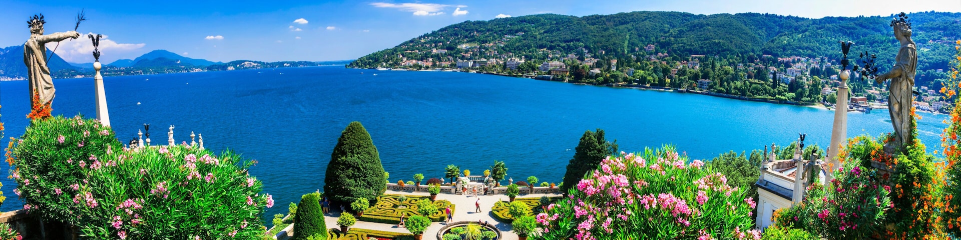 Ultra-wide panorama of Isola Madre botanical gardens and Lake Maggiore. Scenic aerial-style view of Borromean Islands and Alpine lake landscape, Italy.