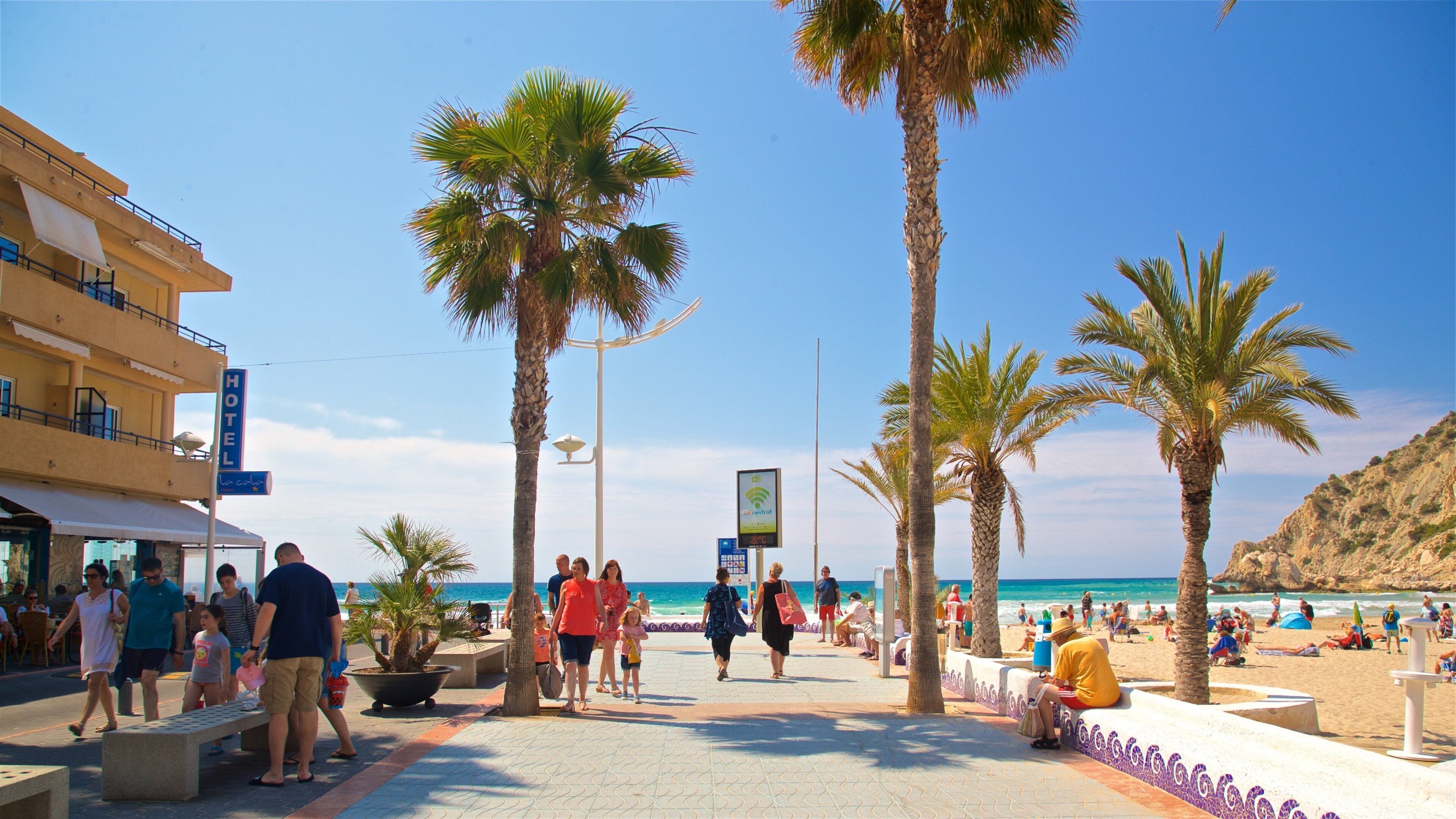 La Cala Beach featuring a coastal town as well as a couple